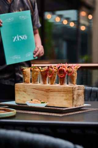A row of filled sandwiches on a wooden serving stand