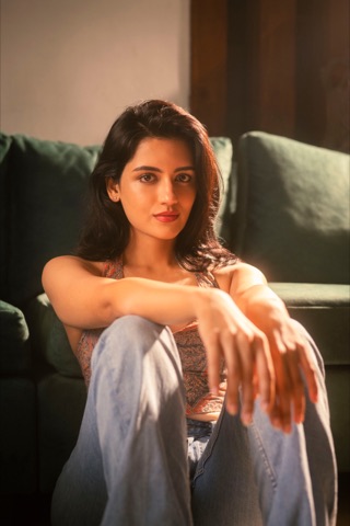 Woman resting her arms on her knees in warm sunlight