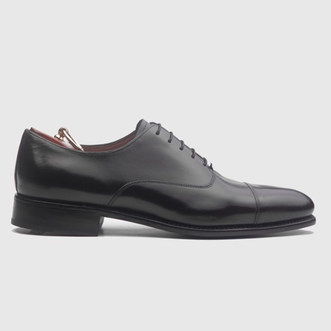 Black leather lace-up shoe shown in profile