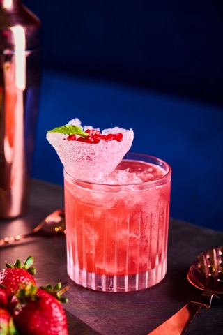 Pink strawberry drink with a decorative ice garnish
