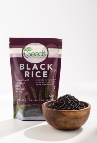 Black rice packet beside a wooden bowl of rice