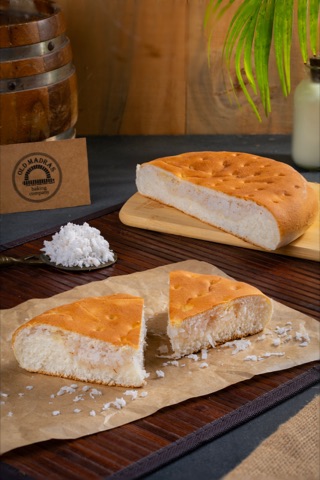 Freshly cut bread on a wooden board with a flour-dusted surface