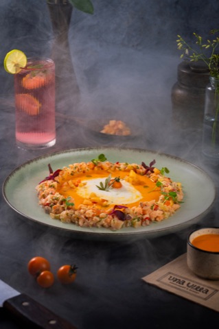 Fried rice topped with a fried egg beside a fruit drink