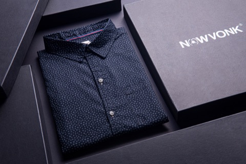 Folded dark shirt presented in a black gift box