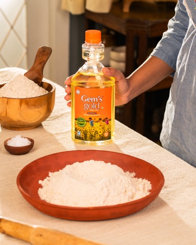 Cooking oil bottle beside flour and coconut in a kitchen setting