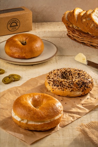 Plain and seeded bagels arranged with bread and butter