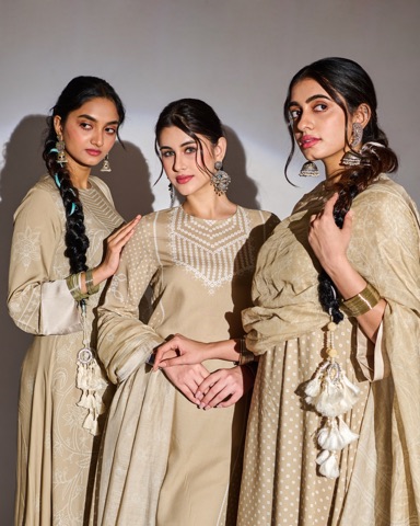 Three women modelling coordinated beige outfits and jewellery