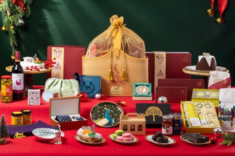 Festive gift hampers and an assortment of sweets on a red table
