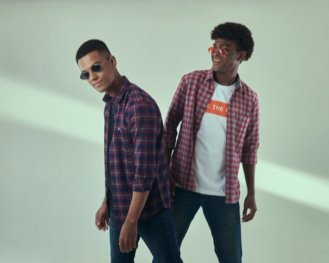 Two men in checked shirts against a pale green backdrop