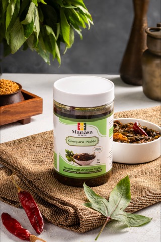 Herbal powder jar with chillies, leaves and a bowl of seasoning