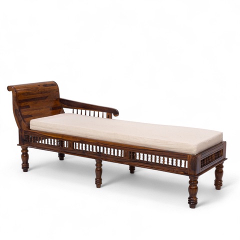 Wooden daybed with a cream cushion against white