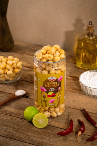 Jar of puffed snacks beside lime, chillies and a bowl