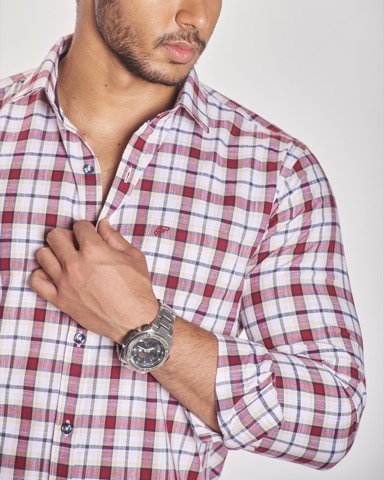 Close-up of a checked shirt sleeve and wristwatch
