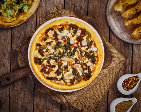 Pizza photographed from above on a rustic wooden table