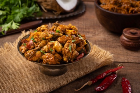 Crisp battered bites in a bowl with red chillies and herbs