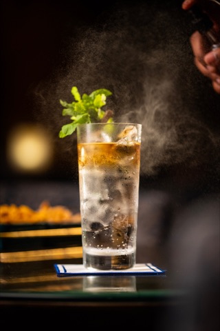 Mint-topped iced drink with mist rising above the glass