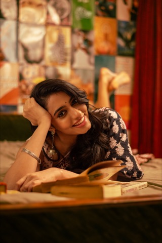 Woman resting her head on her hand beside an open book