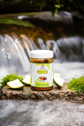Aloe vera gel jar with aloe slices beside flowing water