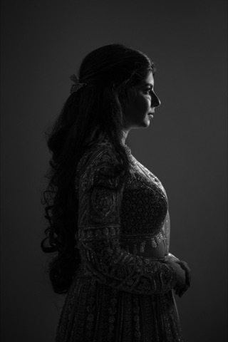 Black-and-white silhouette of a woman in an embroidered outfit