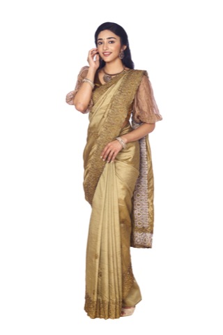Woman modelling a gold-toned sari against a white background